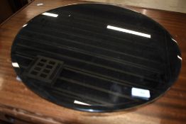 A modern circular framed wall mirror