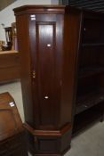 A corner gun cabinet having steel internal cabinet encased in mahogany , with lower cupboard