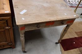 A Victorian stripped side table, having double drawer on turned legs and castors, width approx 76cm,