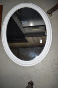 A classical style painted oval wall mirror