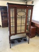 An Edwardian mahogany display cabinet having inlay decoration on slender tapered legs, damage to