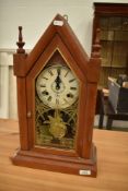 A reproduction mantel clock in the Victorian gothic style