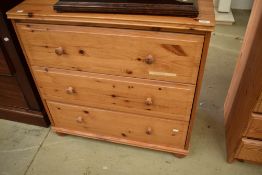 A modern pine chest of three long bedroom drawers