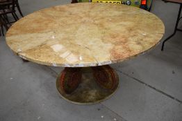 A large circular table having octopus style base with velvet lining