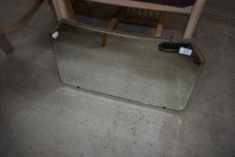 A vintage frameless wall mirror