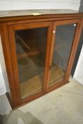 A 19th Century stained pine cased glazed book shelf having rolled plate glass doors