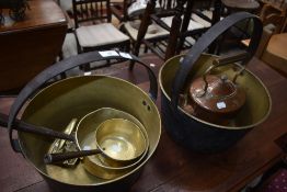 A selection of brass and copperware including jam pans and copper kettle