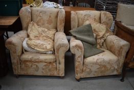 A pair of traditional wing back armchairs
