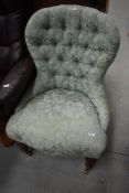 A reproduction button back nursing chair in the Victorian style