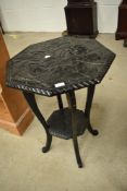 An Oriental style black laquered octagonal occasional table
