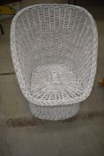 A wicker painted tub style chair