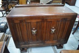 An early 20th Century oak sideboard having brass deco style handles and bi-fold doors, width approx.