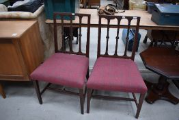 A pair of reproduction Regency dining chairs having recovered tweed seats
