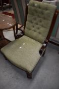 A 19th Century button back nursing chair having mahogany frame and later upholstery