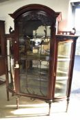 A 19th Century mahogany and glass display cabinet having triple display sections, velvet lined