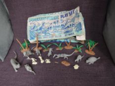 A 1960's Marx plastic Prehistoric Play Set comprising 8 Dinosaurs, 4 Cavemen, Tree's and Ferns, in