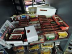 A shelf of Matchbox Models of Yesteryear, EFE and similar diecast Buses and Advertisng Vans, all