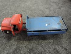 A Triang Tin plate Flat Bed Articulated Wagon having red tractor unit and blue trailer with black