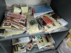 Two shelves of Hachette Your Model Railway Village magazines and accessories, all appear unused