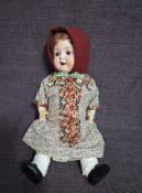 An early 20th century Armand Marseille bisque headed doll having sleep brown eyes, open mouth with