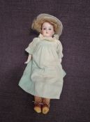 An early 20th century Armand Marseille bisque headed doll having sleep blue eyes, open mouth with f