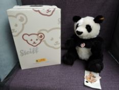 A modern Steiff Panda 060144 with yellow tag and button, boxed,