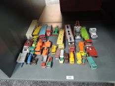 A shelf of Matchbox playworn diecasts including Construction, Car Carriers etc