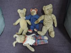 Three early 20th century straw filled Teddy Bears all having joined bodies including red mohair