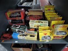 A shelf of modern diecasts including Burago 1:18 scale Jaguar E Coupe 1961, 1:24 scale Mercedes