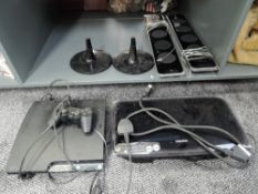 A PS3 Games Console with controller and a Samsung Home Cinema System with two speakers on stands