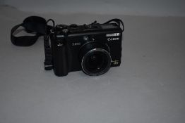 A Canon G5 Powershot camera with remote, charger and soft bag