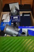 A box containing various photographic equipment including a lens light, Leica Hektor 85mm