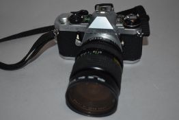 A Pentax and Petri camera. A Pentax MEF camera with Cosina 28-70mm lens, and a Petri TTL camera with