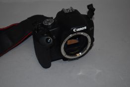 A Canon EOS 500D body with manual in soft bag