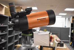 A Celestron Nexstar SE4 computerised telescope with various eye pieces