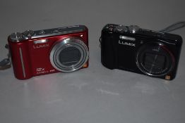 Two Panasonic Lumix cameras. A DMC TZ30 and a DMC TZ27 with manuals