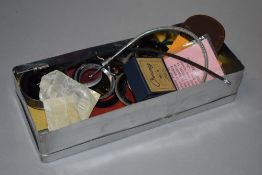 A vintage tin box of accessories including filters etc