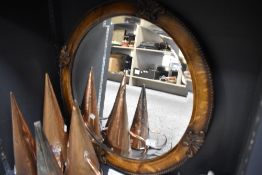 A circular 1920's oak-framed bevelled mirror