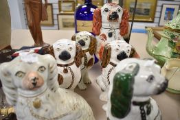 A group of six Victorian Staffordshire pottery spaniels, including one pair and one green and puce