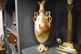 An early 20th century Crown Devon vase, in the blush ivory style, hand-painted with pheasants and