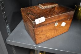 A 19th century rosewood tea caddy, of sarcophagus form, with circular Mother-of-Pearl escutcheon