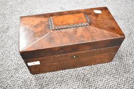 A 19th century mahogany sarcophagus-form tea caddy, with internal compartments and replacement glass