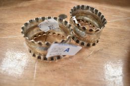 A pair of hallmarked silver napkin rings, with crimped and engraved detail 48grams gross.