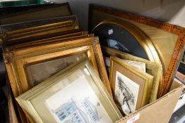 A box of mixed vintage and modern frames and prints.