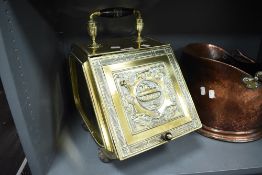 A late Victorian brass coal scuttle, the hinged cover embossed with classical urn and borders,