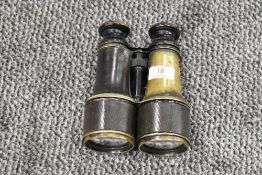 A pair of 19th century leather-mounted patinated brass field glasses, most likely continental