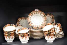 A selection of early 20th century English plates,cups and saucers having hand tinted transfer