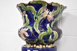 An early 20th century jardinière and pedestal, with moulded foliate decoration painted in the