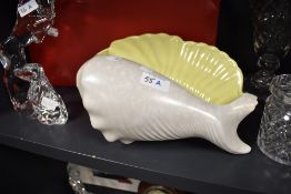 A Poole pottery conch shell, in mottled grey with contrasting yellow interior.