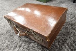 A vintage stitched brown leather suitcase, with partially fitted interior